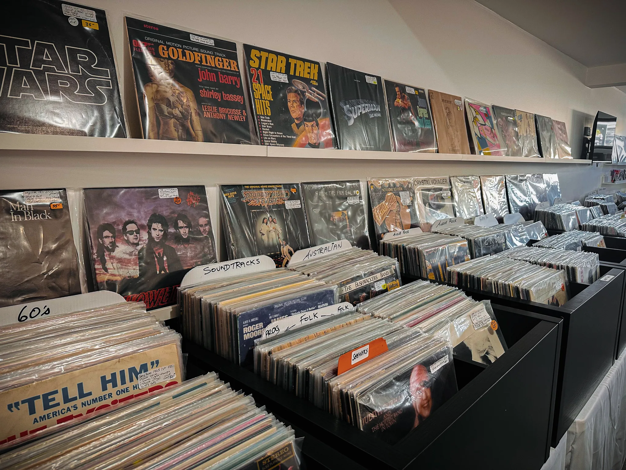 In-store shelves of soundtrack and rock records — Star Wars, Goldfinger, Star Trek and Saturday Night Fever — above genre-labelled vinyl crates